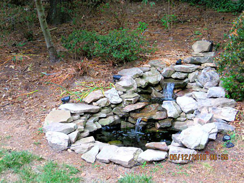 Photo of a hardscaped rock waterfall